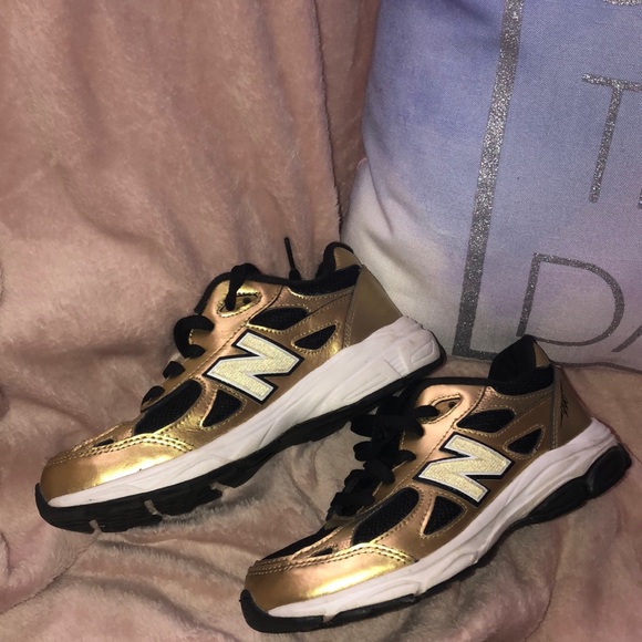 gold and black new balance 990
